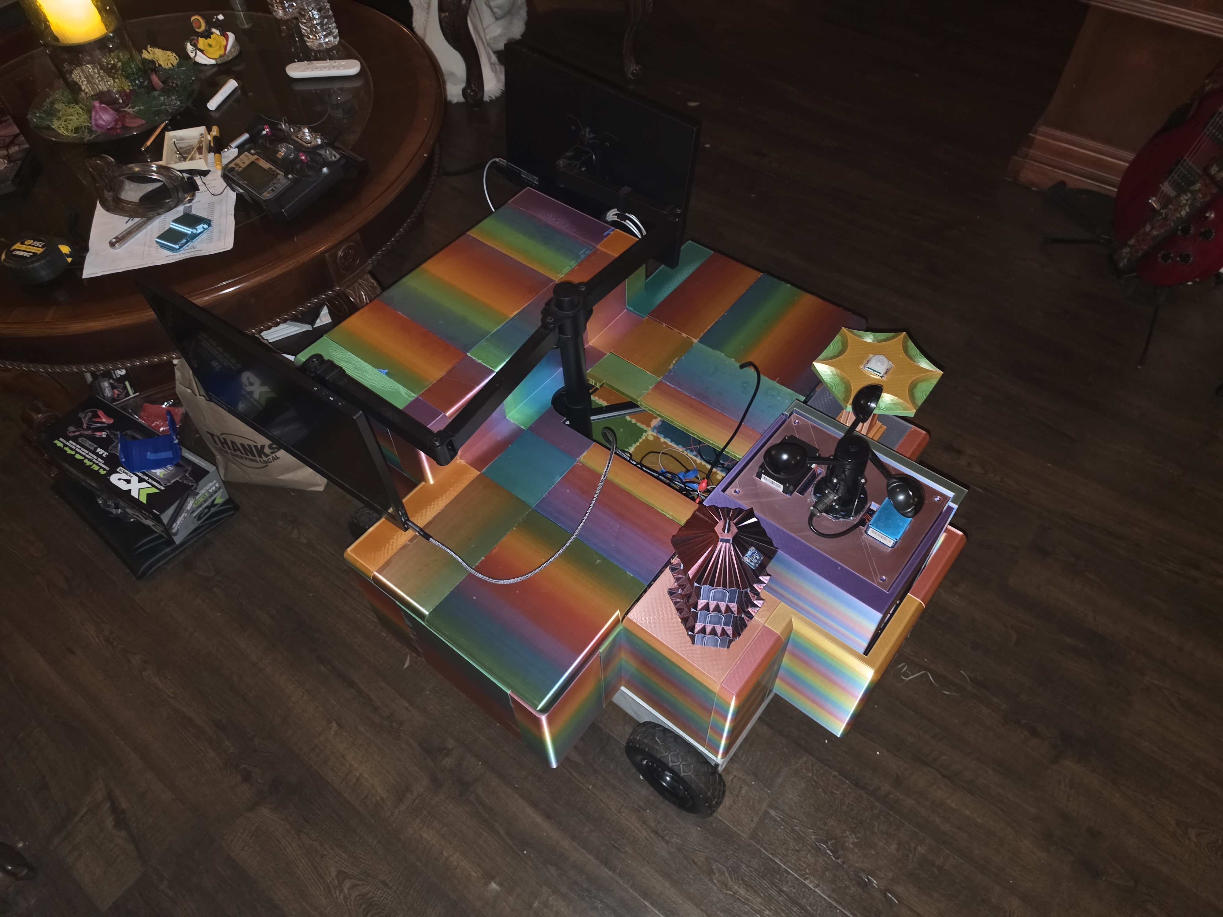 Angled view of the RumPi robot with its monitor arm and sensor cluster